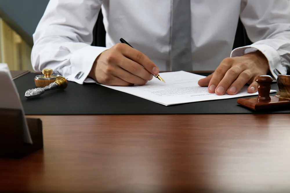 Photo of a man writing papers at the table