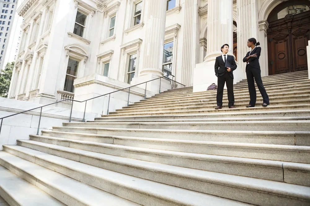 Photo of two people standing on stairs