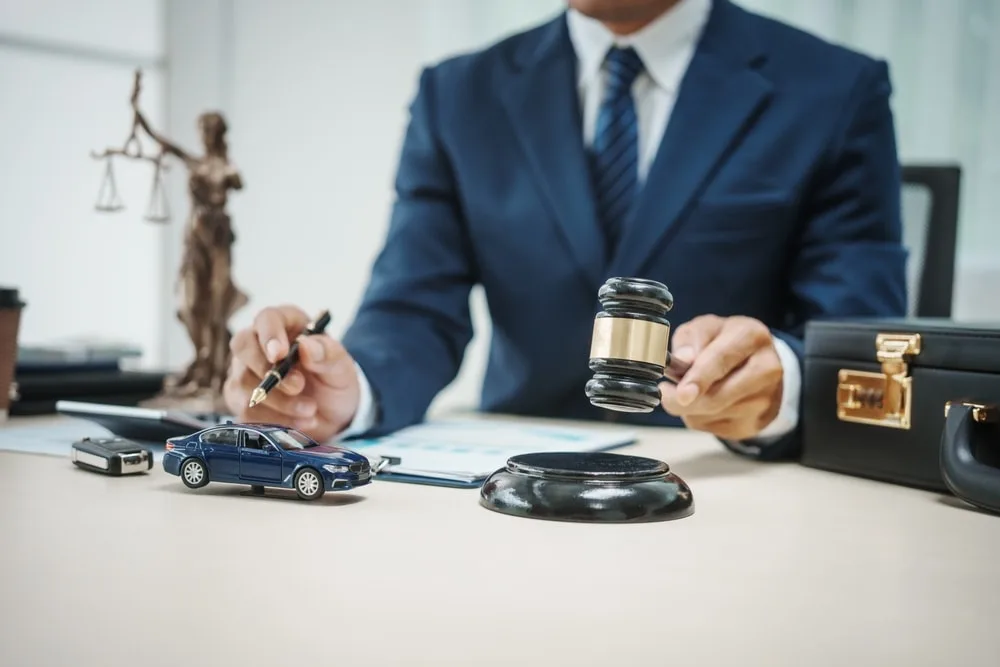 Car accident lawyer with a gavel in hand overlooking documents