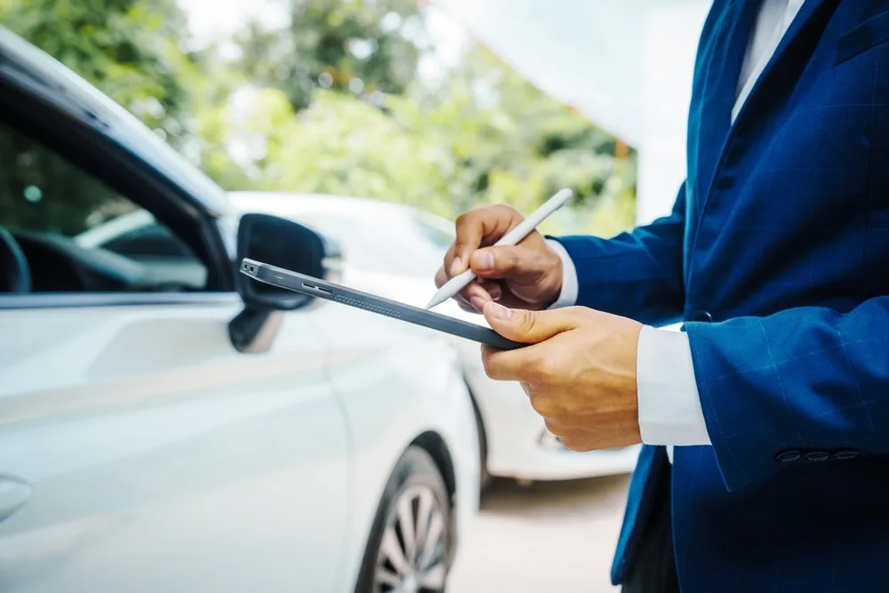 Professional assessing vehicle's worth after an accident